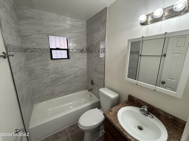 full bathroom featuring tile patterned flooring, vanity, toilet, and tiled shower / bath combo