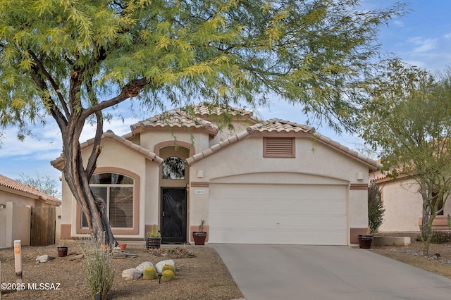 mediterranean / spanish-style home featuring a garage