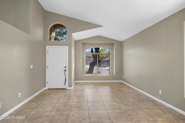 living room featuring light tile patterned floors, high vaulted ceiling, and a notable chandelier