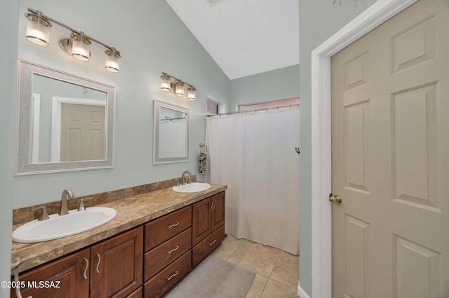 bathroom with tile patterned floors, vanity, a shower with curtain, and vaulted ceiling