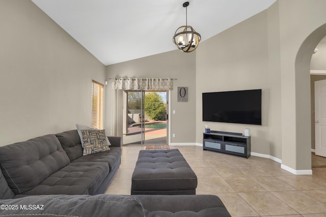 tiled living room with an inviting chandelier and high vaulted ceiling