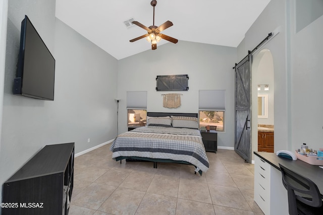 tiled bedroom featuring ceiling fan, a barn door, high vaulted ceiling, and ensuite bath