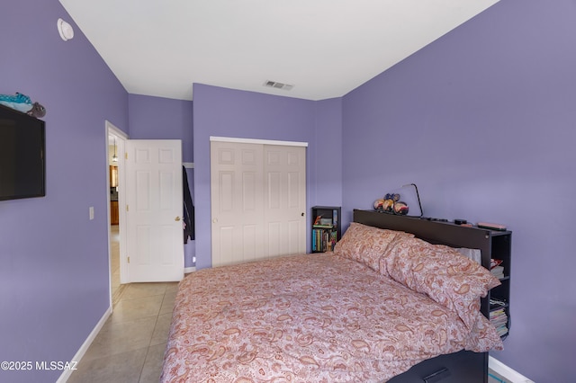 bedroom with light tile patterned floors and a closet