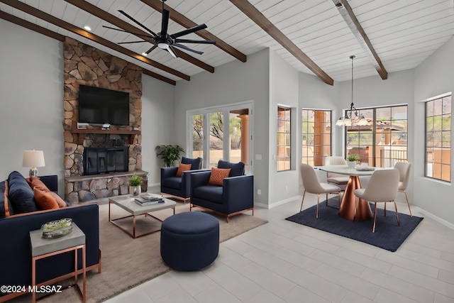 living room with high vaulted ceiling, ceiling fan with notable chandelier, a fireplace, beamed ceiling, and wood ceiling