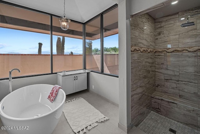 bathroom with tile patterned flooring, vanity, and separate shower and tub