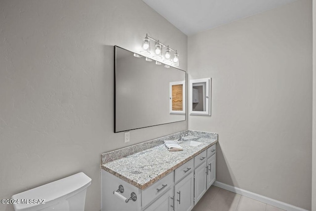 bathroom with tile patterned floors, vanity, and toilet