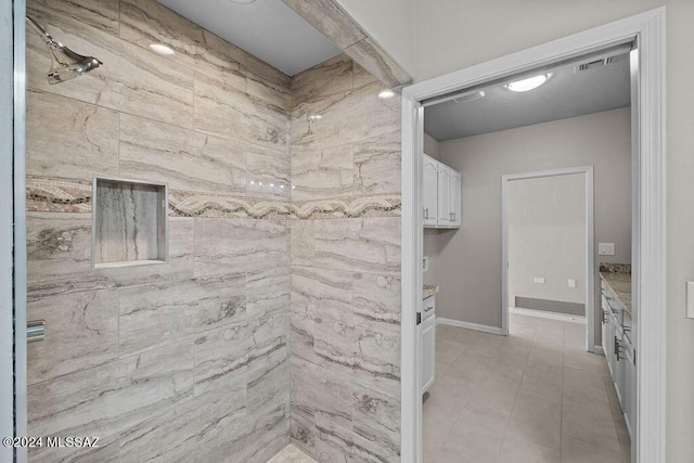 bathroom featuring tile patterned floors and tiled shower