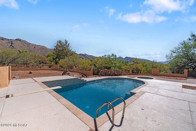 view of pool with a mountain view and a patio