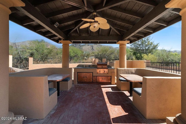 view of patio with a gazebo, ceiling fan, area for grilling, and an outdoor bar