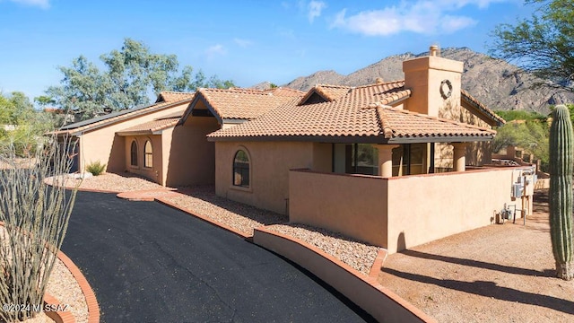 mediterranean / spanish house featuring a mountain view