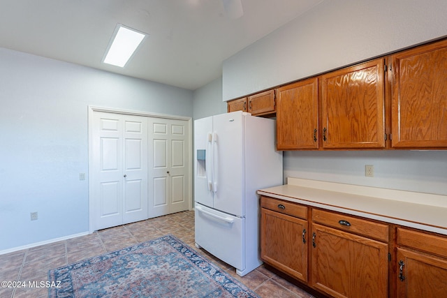 kitchen with white fridge with ice dispenser