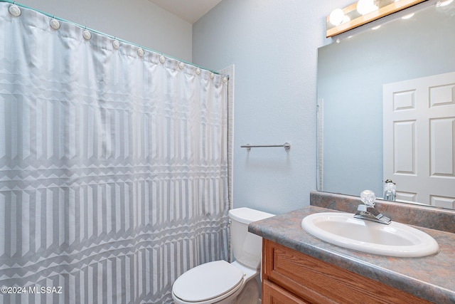 bathroom with vanity, toilet, and walk in shower