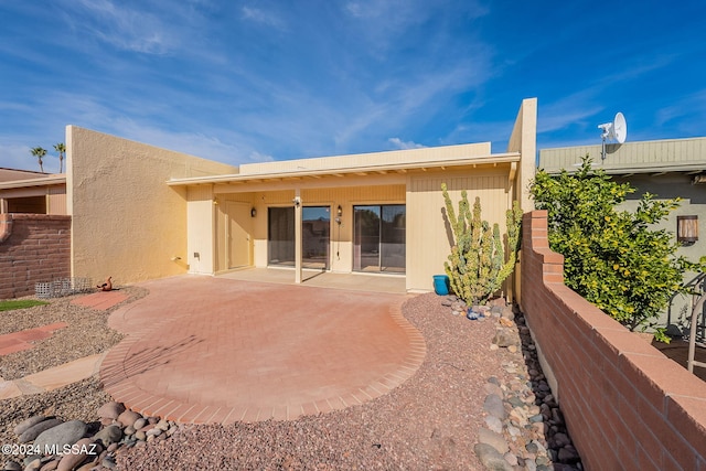 back of house with a patio