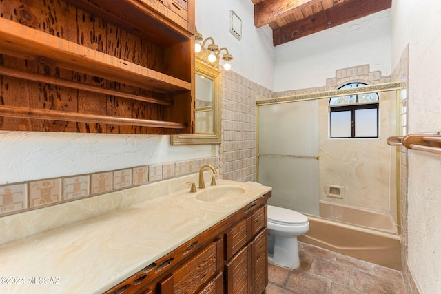 full bathroom featuring beamed ceiling, vanity, toilet, and bath / shower combo with glass door