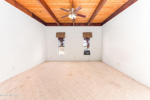 unfurnished room featuring beamed ceiling, carpet floors, and ceiling fan