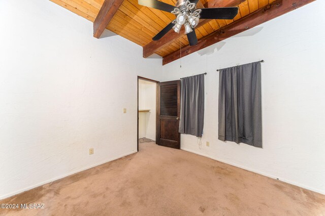 unfurnished bedroom with carpet flooring, vaulted ceiling with beams, ceiling fan, and wooden ceiling