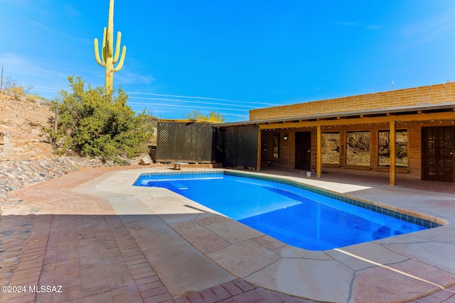 view of swimming pool featuring a patio area