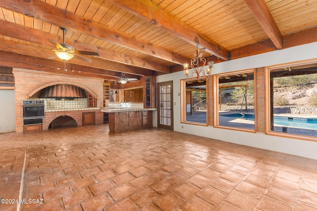 interior space with ceiling fan and area for grilling