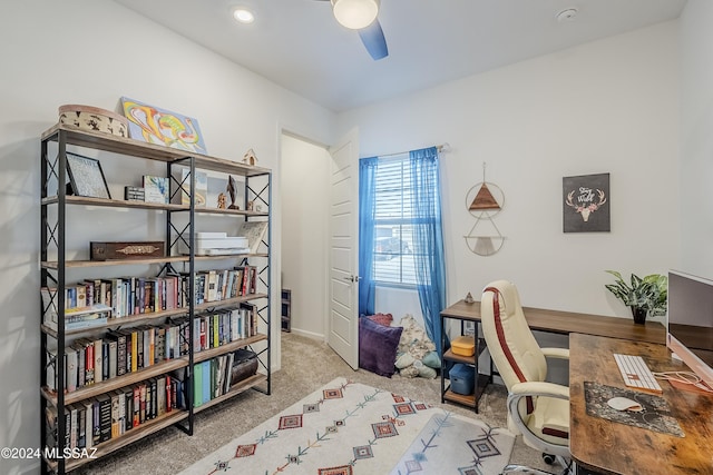 office space with ceiling fan and light colored carpet