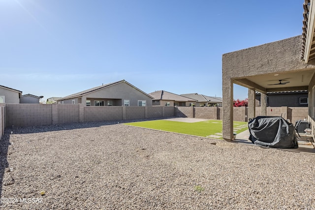 view of yard with a patio area and ceiling fan