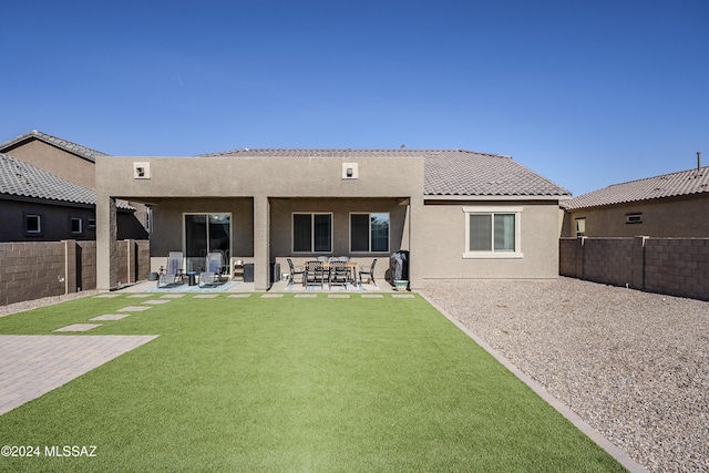 rear view of property featuring a patio area and a yard