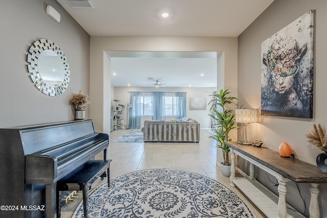 misc room with ceiling fan and light tile patterned flooring