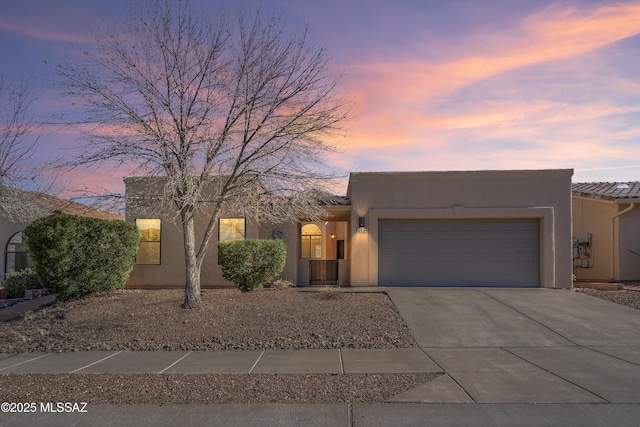 pueblo revival-style home with a garage