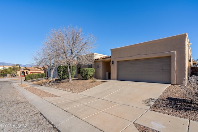 pueblo-style home with a garage