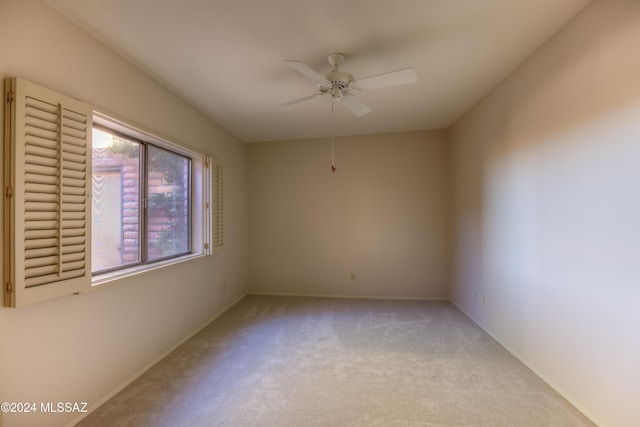 empty room with light colored carpet and ceiling fan