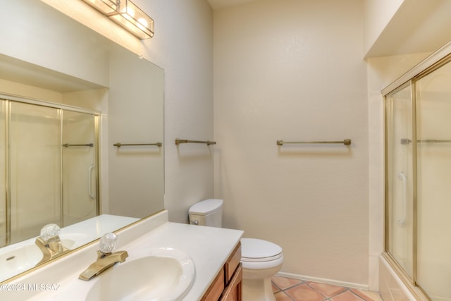 full bathroom featuring tile patterned floors, vanity, bath / shower combo with glass door, and toilet