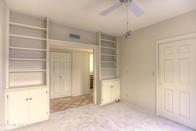 unfurnished bedroom with ceiling fan and light carpet