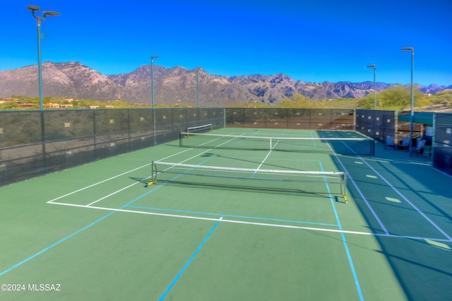 view of tennis court with a mountain view