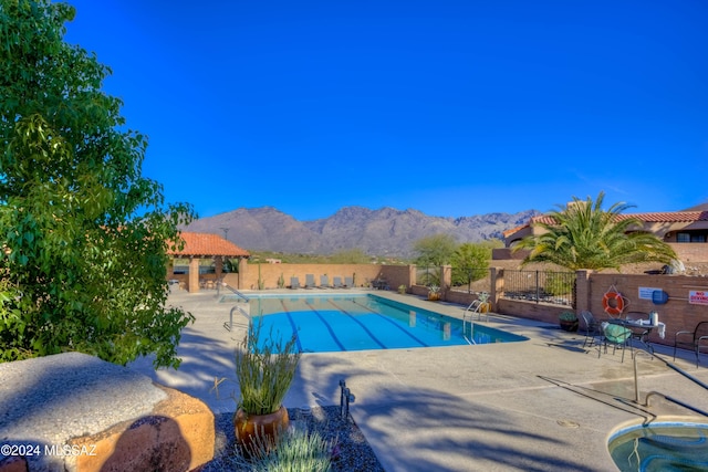 view of pool with a gazebo, a mountain view, and a patio