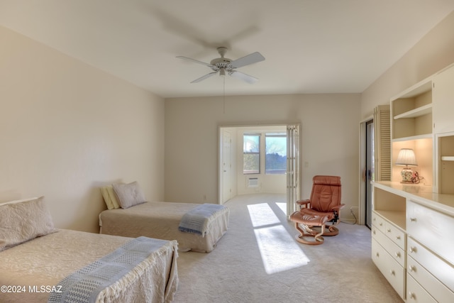 bedroom featuring light colored carpet and ceiling fan