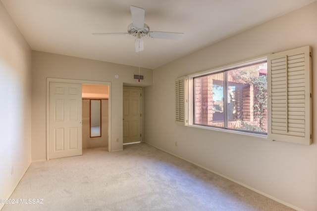 unfurnished bedroom with ceiling fan and light carpet