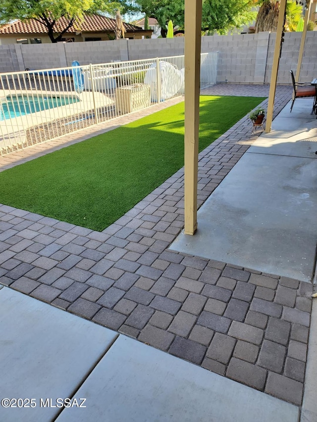 view of patio / terrace with a fenced in pool