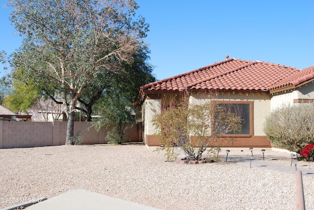 view of side of home featuring a patio area