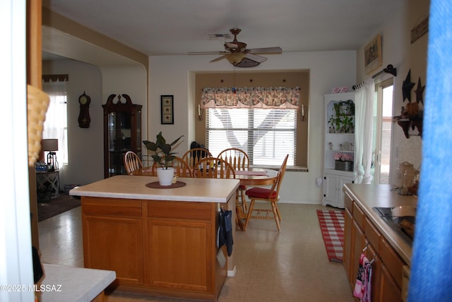 kitchen featuring ceiling fan and a kitchen island