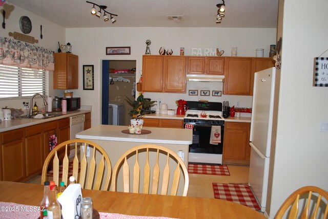 kitchen with a center island, white gas range, and sink