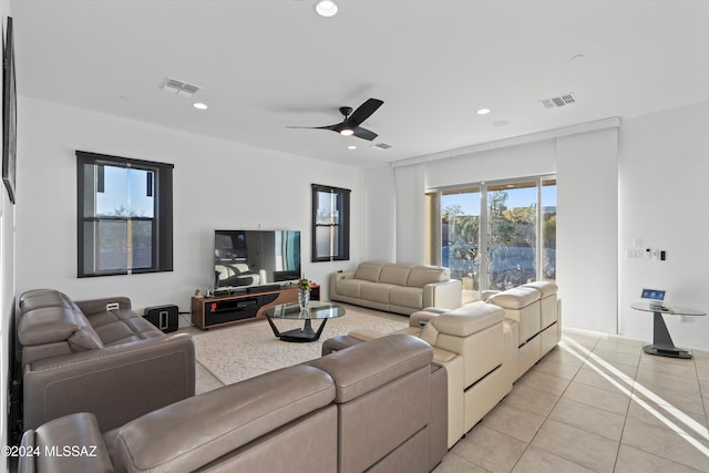 living room featuring ceiling fan and light tile patterned flooring