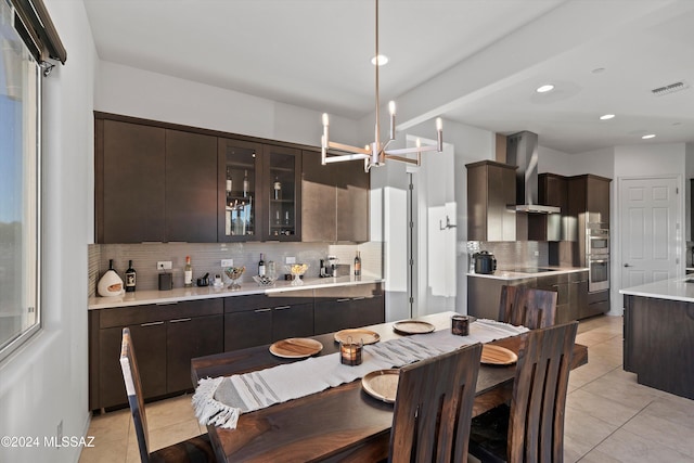 tiled dining space featuring a notable chandelier