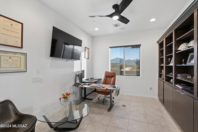 tiled office space featuring ceiling fan