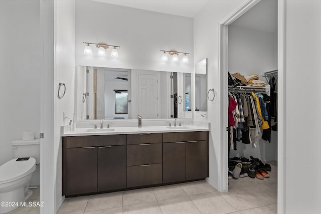 bathroom featuring tile patterned floors, vanity, and toilet