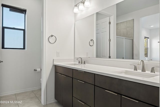 bathroom featuring toilet, vanity, tile patterned floors, and walk in shower