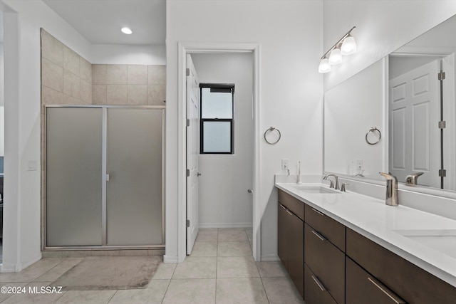 bathroom featuring tile patterned floors, vanity, and walk in shower