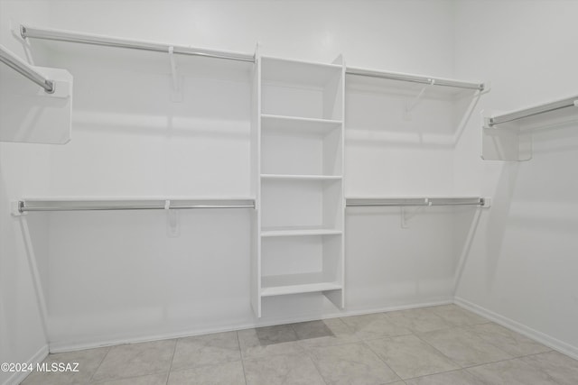 spacious closet with light tile patterned floors