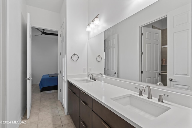 bathroom with tile patterned flooring, vanity, and ceiling fan