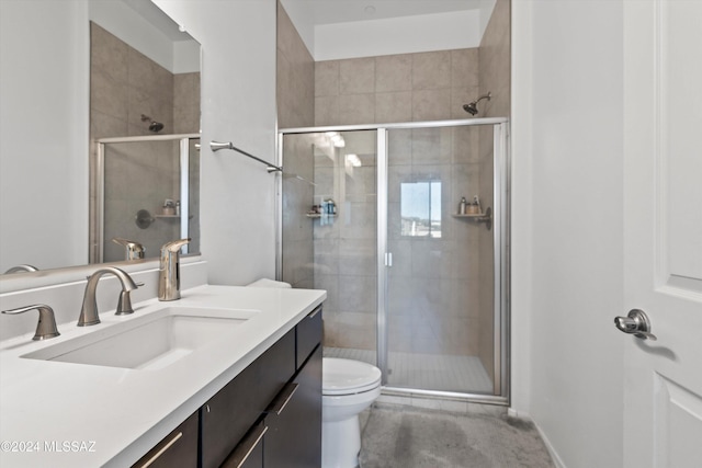 bathroom featuring vanity, toilet, and an enclosed shower