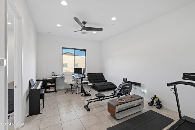 workout room with ceiling fan and light tile patterned floors