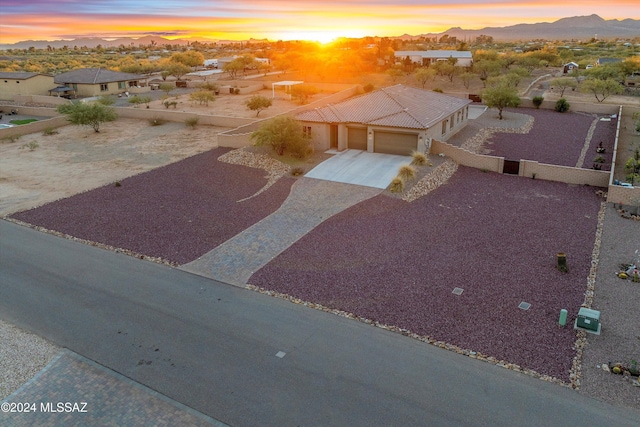 aerial view at dusk featuring a mountain view